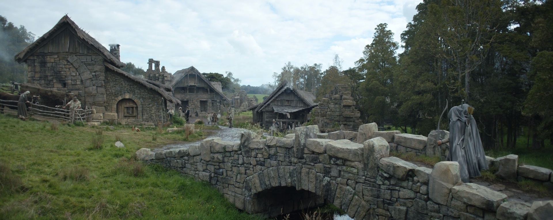 Large stone bridge and village structures engineered for a screen production